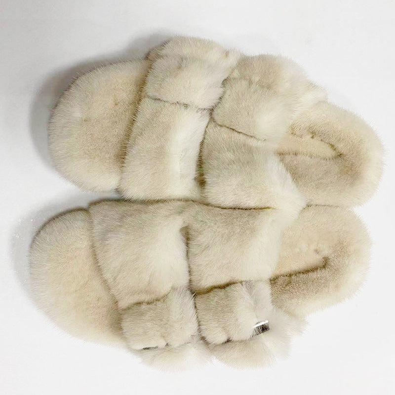 Pair of fur slippers on a white background