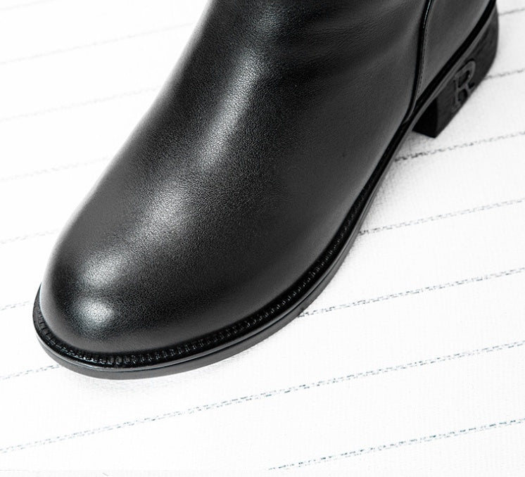 Black leather boot on a white background