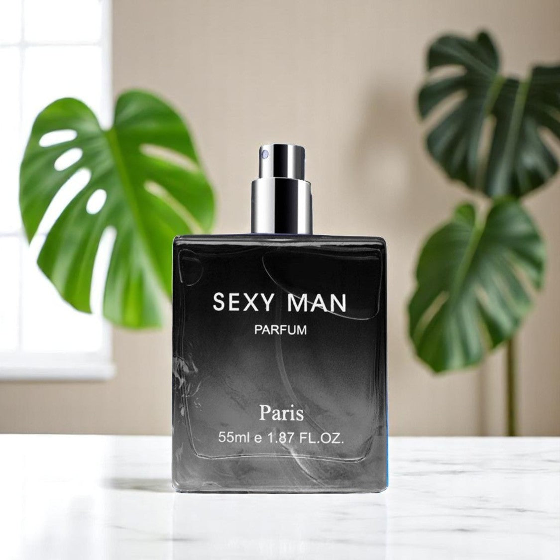 Perfume bottle labeled 'Sexy Man Parfum' on a surface with green leaves in the background