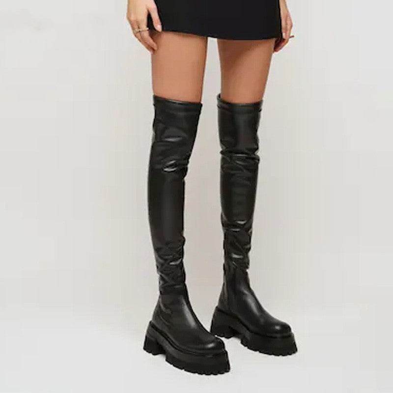 Black leather knee-high boots on a plain background