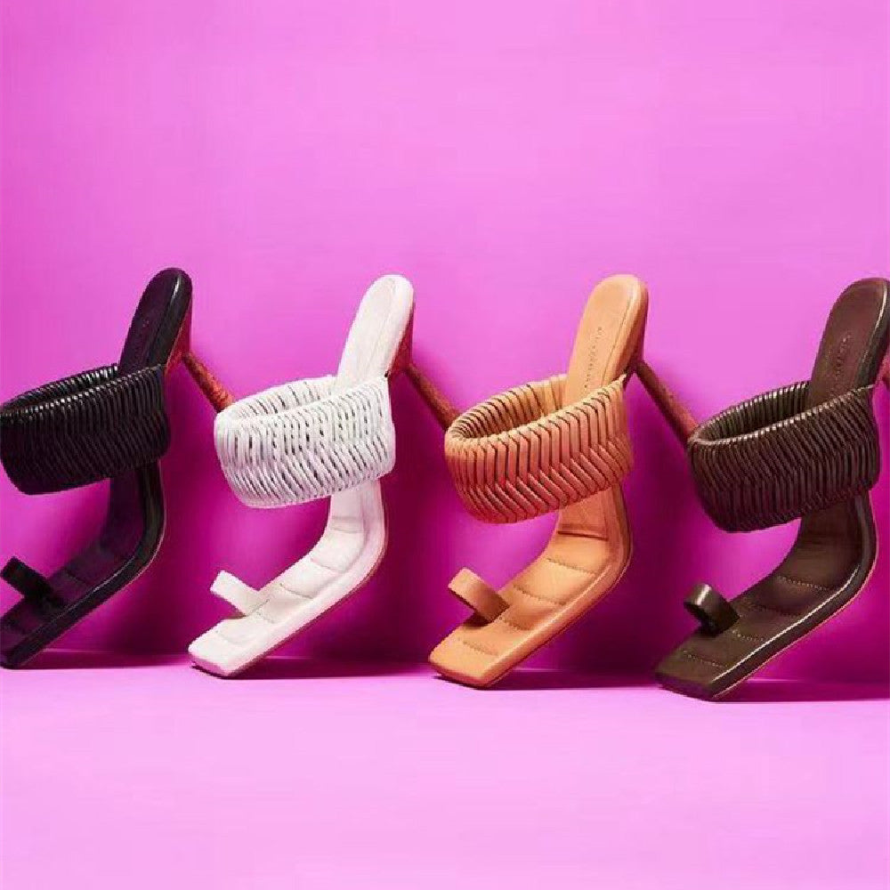 Five pairs of high-heeled shoes in different colors on a pink background