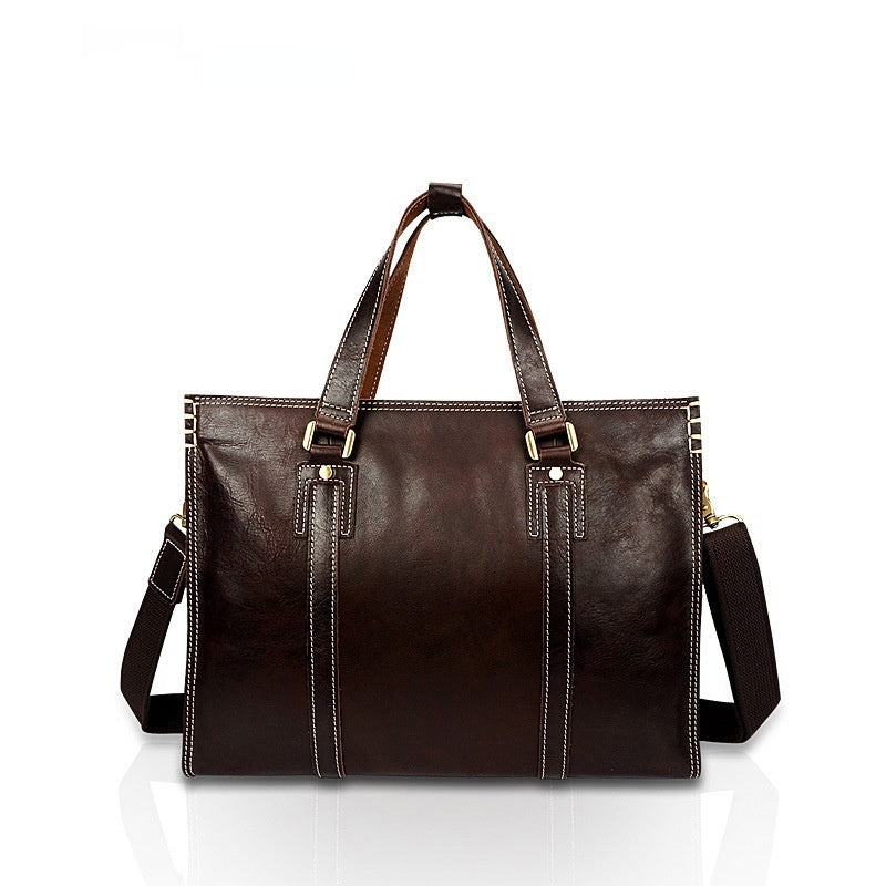 Brown leather tote bag with shoulder strap on a white background