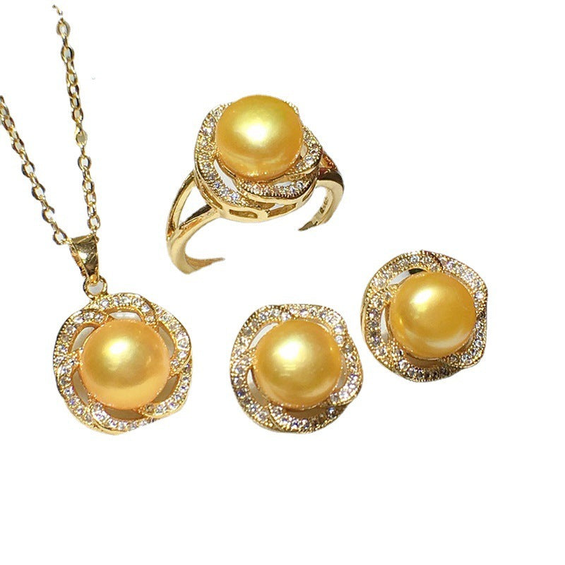 Gold jewelry set with pearls on a white background