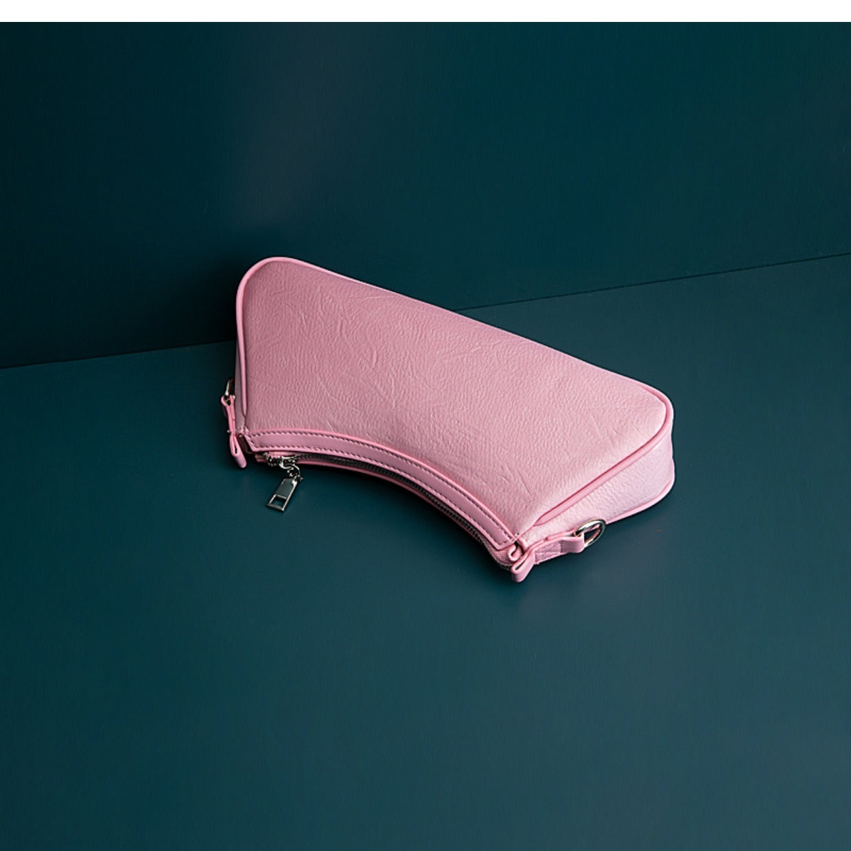 Pink travel case on a dark green background
