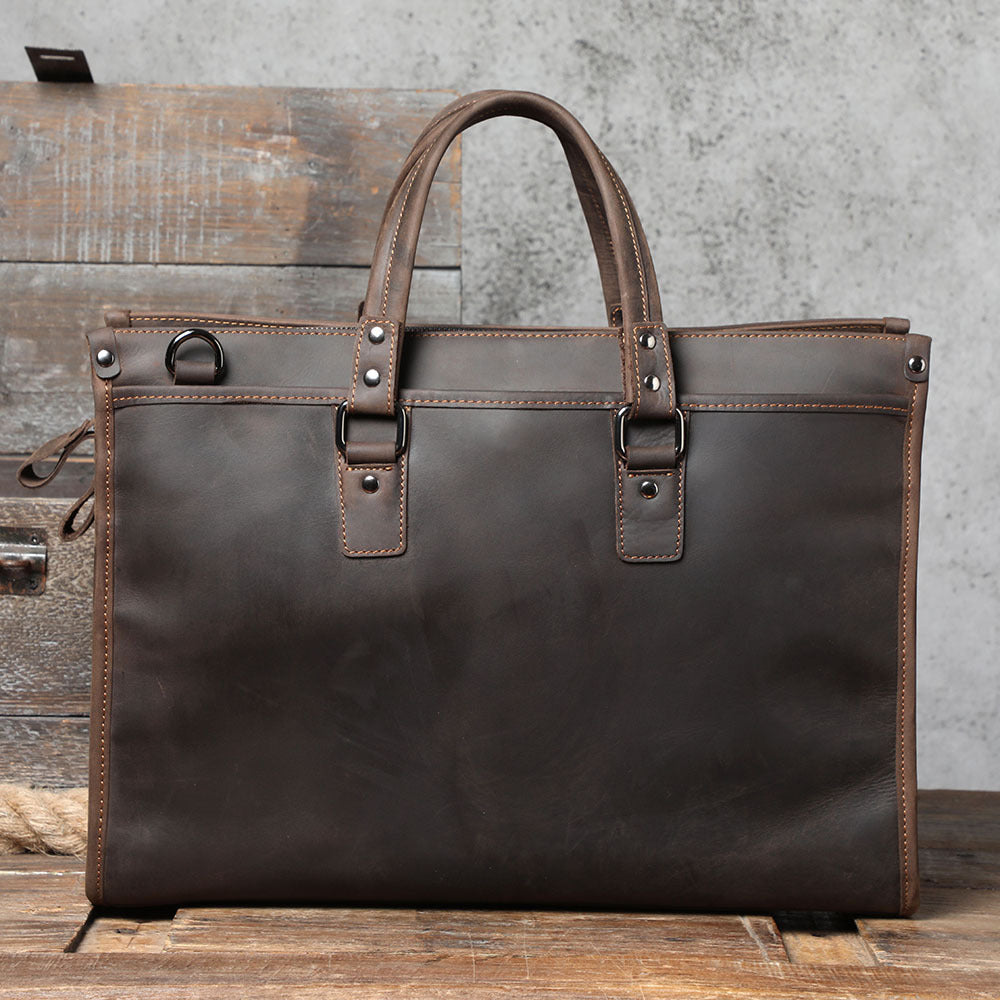 Brown leather briefcase on a wooden surface with a rustic background