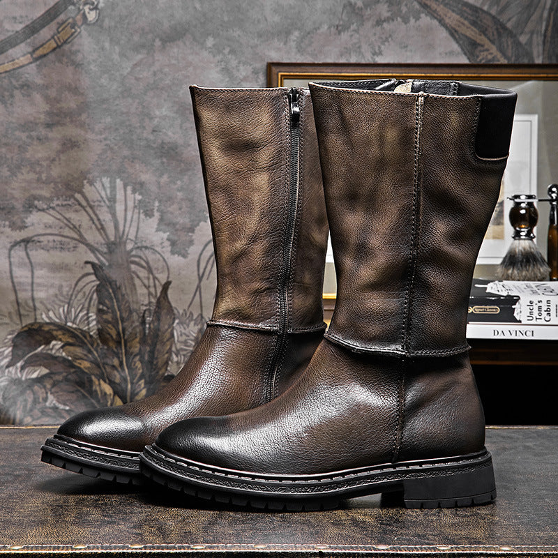 Pair of brown leather boots on a textured surface with a decorative background