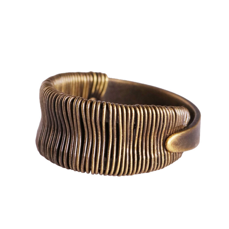 Bronze bracelet with wavy pattern on a white background