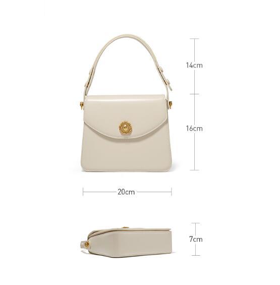 Beige handbag with dimensions labeled on a white background