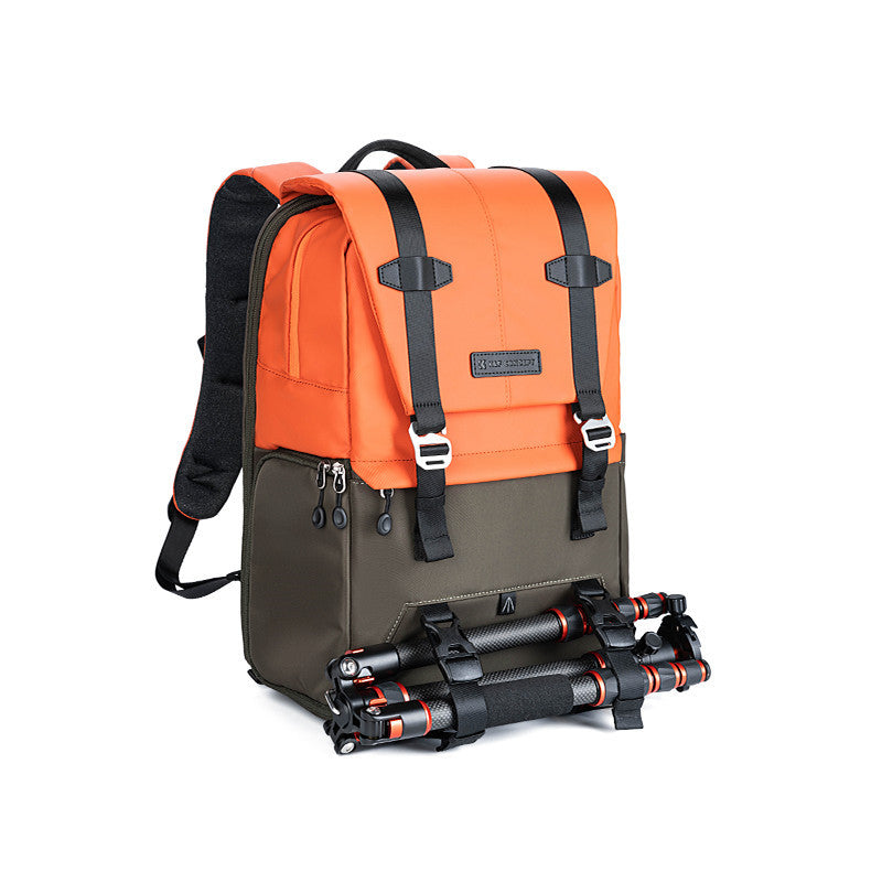 Orange and black backpack with a camera tripod on a white background