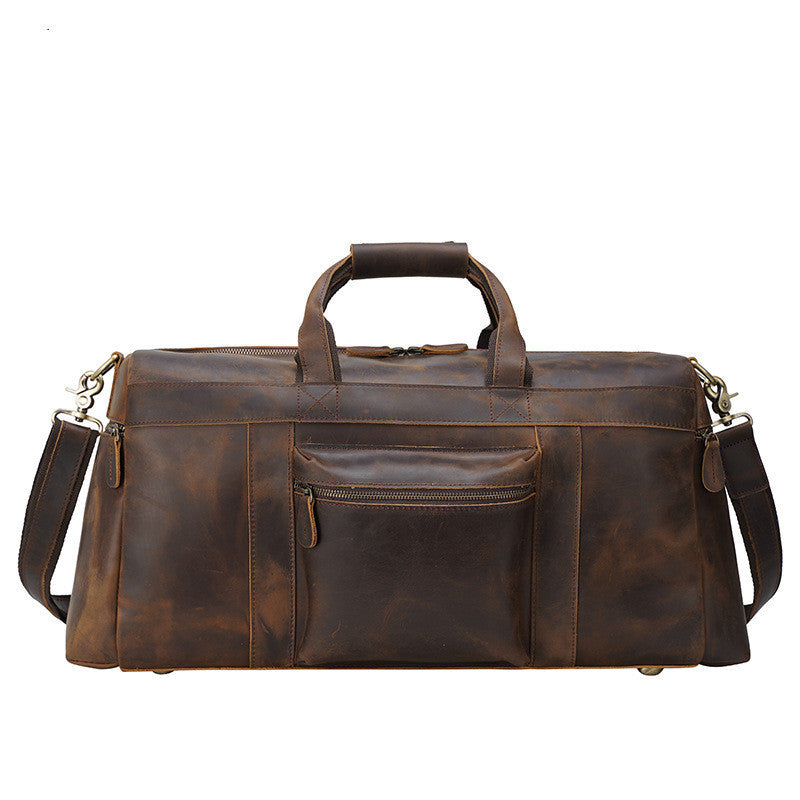 Brown leather duffel bag with multiple pockets on a white background