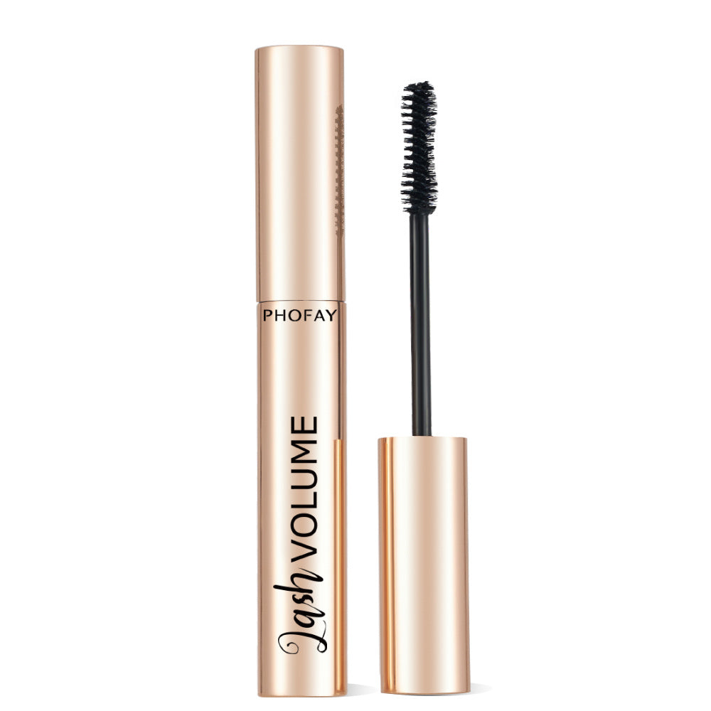 Mascara with gold tube and black brush on a white background