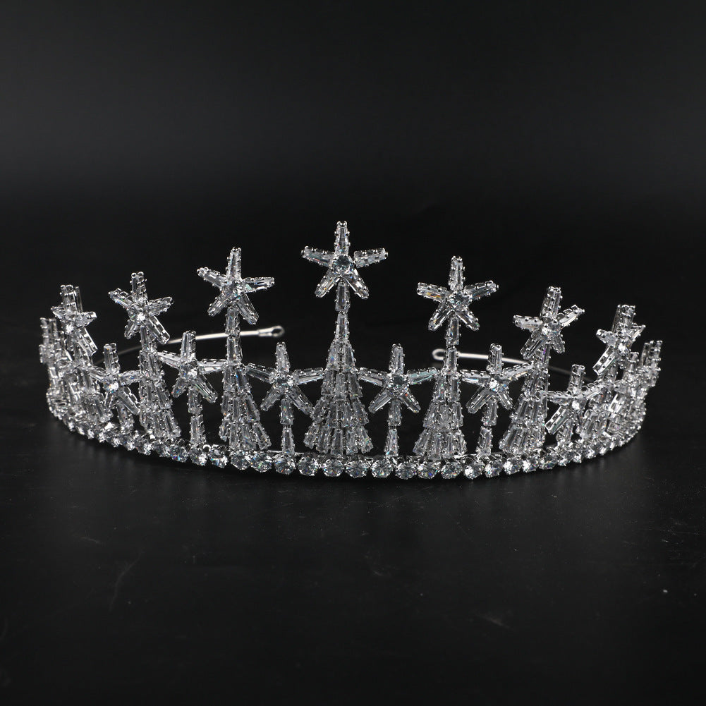 Silver tiara with star designs on a black background