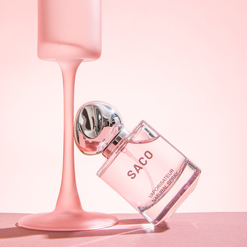 SACO perfume bottle with a pink background