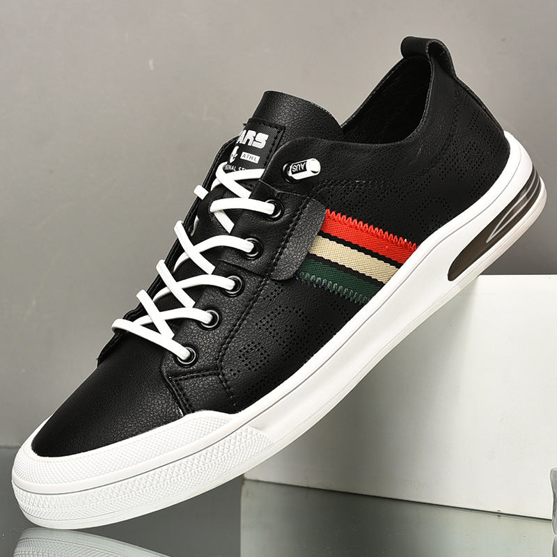 Black sneaker with white laces and a colorful stripe on a gray background