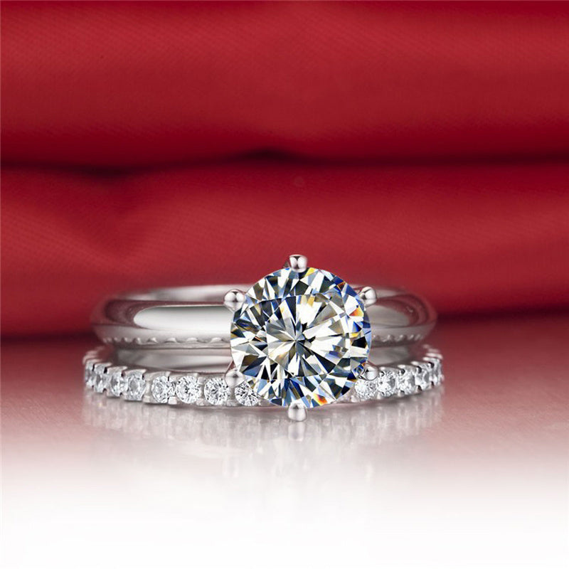 Diamond ring on a reflective surface with a red fabric background