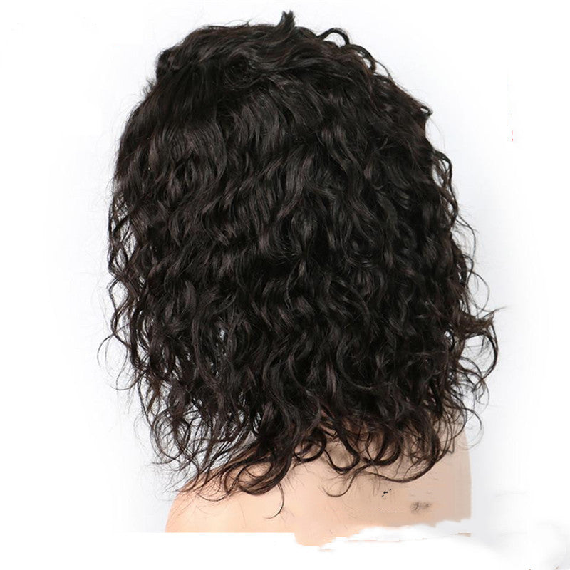 Black curly wig on a mannequin head against a white background