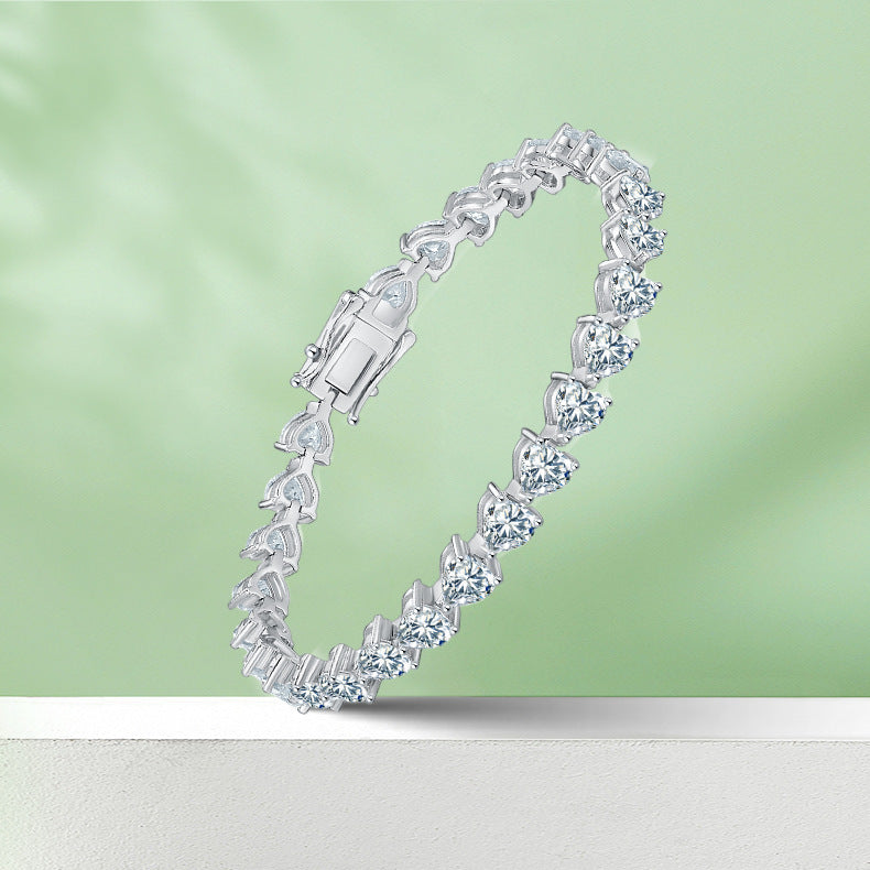 Silver bracelet with clear stones on a light green background