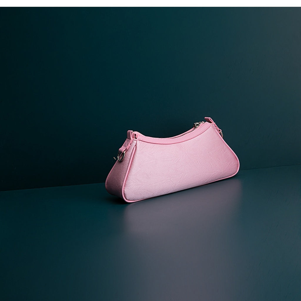 Pink handbag on a dark green background