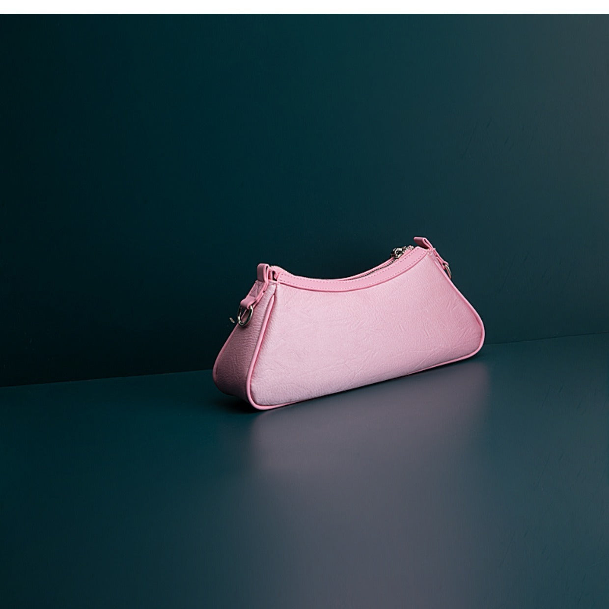 Pink handbag on a dark green background