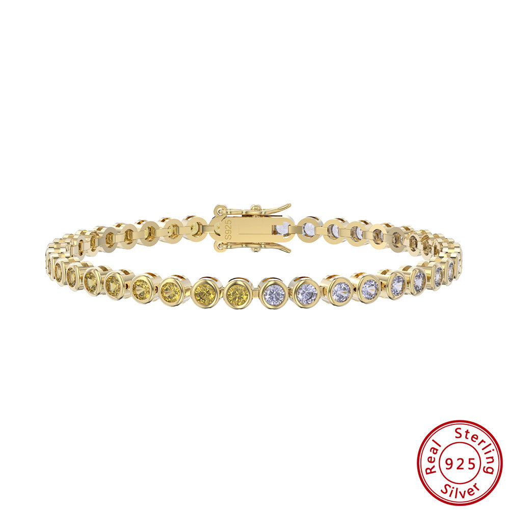 Gold bracelet with clear stones on a white background, featuring 'Real Sterling Silver' stamp.