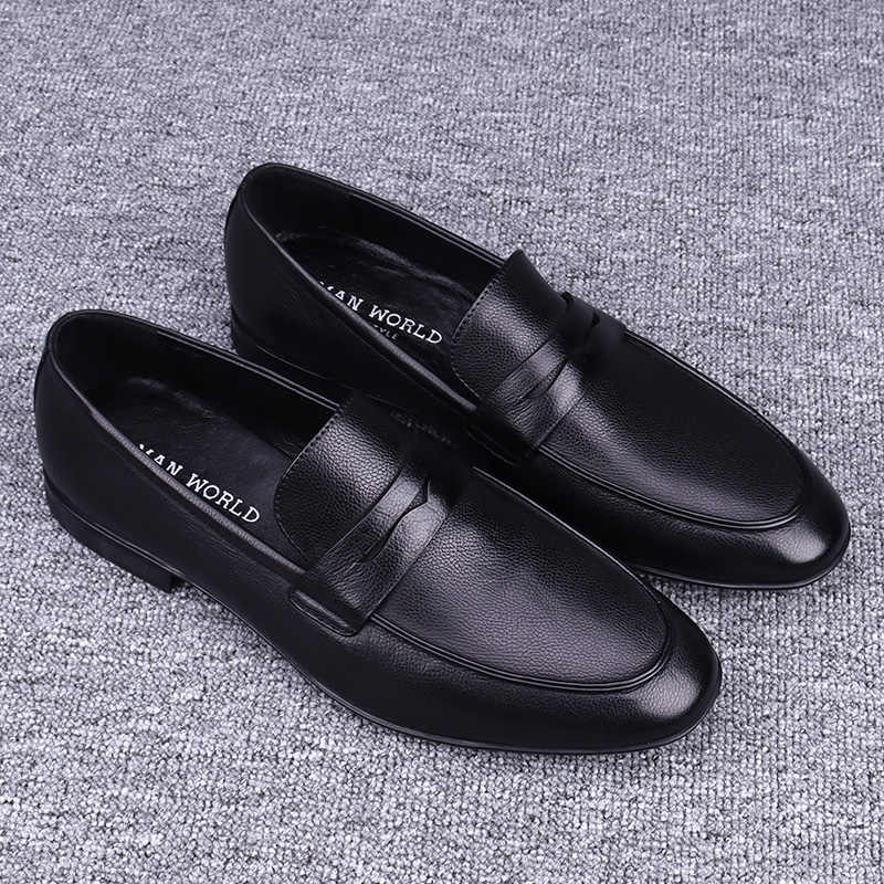 Black leather loafers on a gray textured background