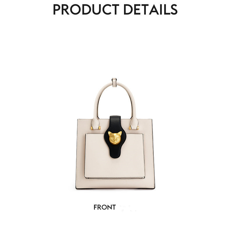 White handbag with black cat face design on a white background