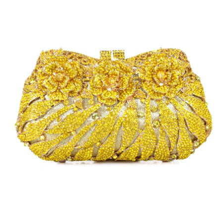 Yellow beaded clutch bag with floral design on a white background