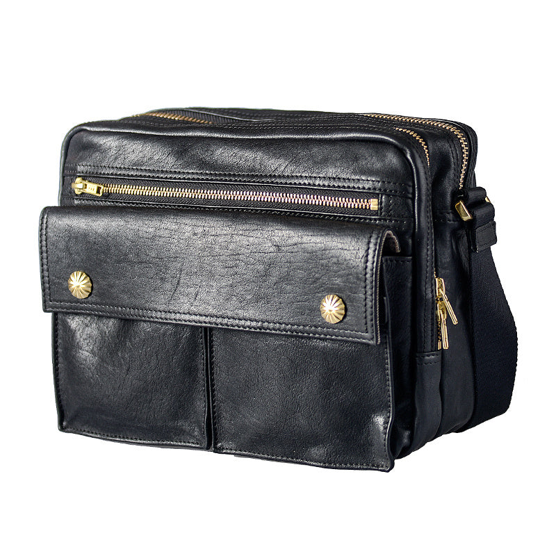 Black leather bag with gold zippers and studs on a white background