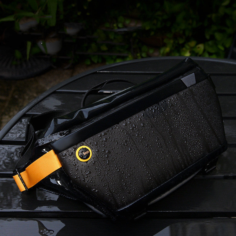 Black and yellow bag with water droplets on a reflective surface