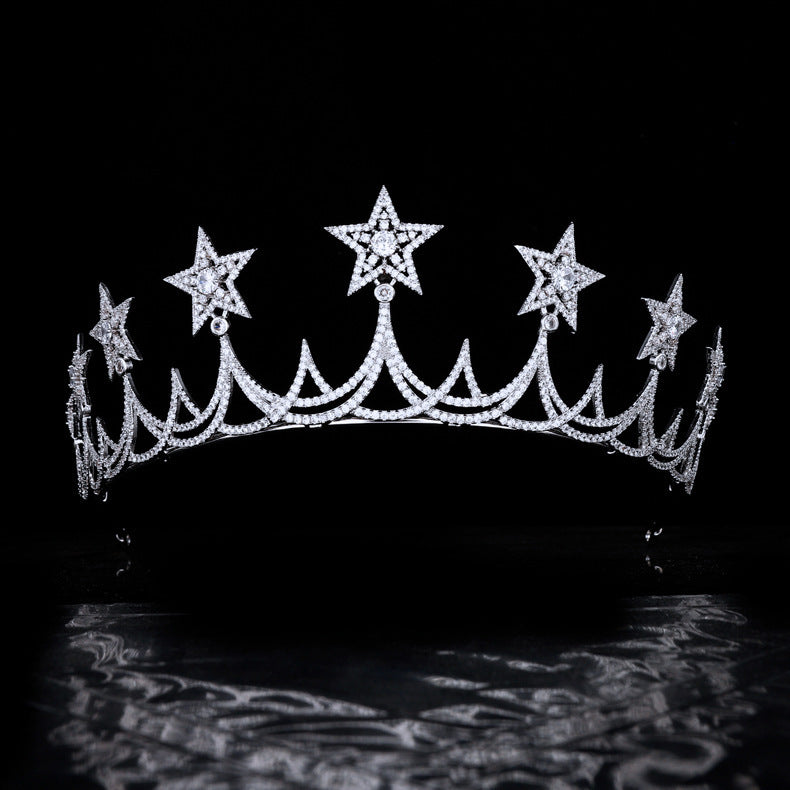 Diamond tiara with star designs on a black background