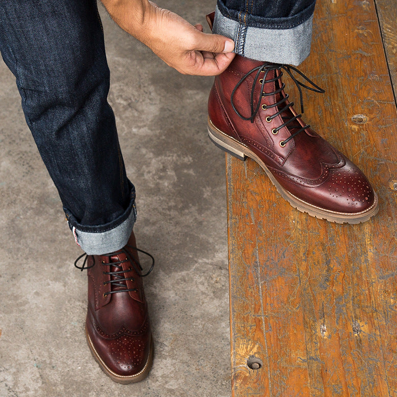 Person wearing brown leather boots on a wooden floor.