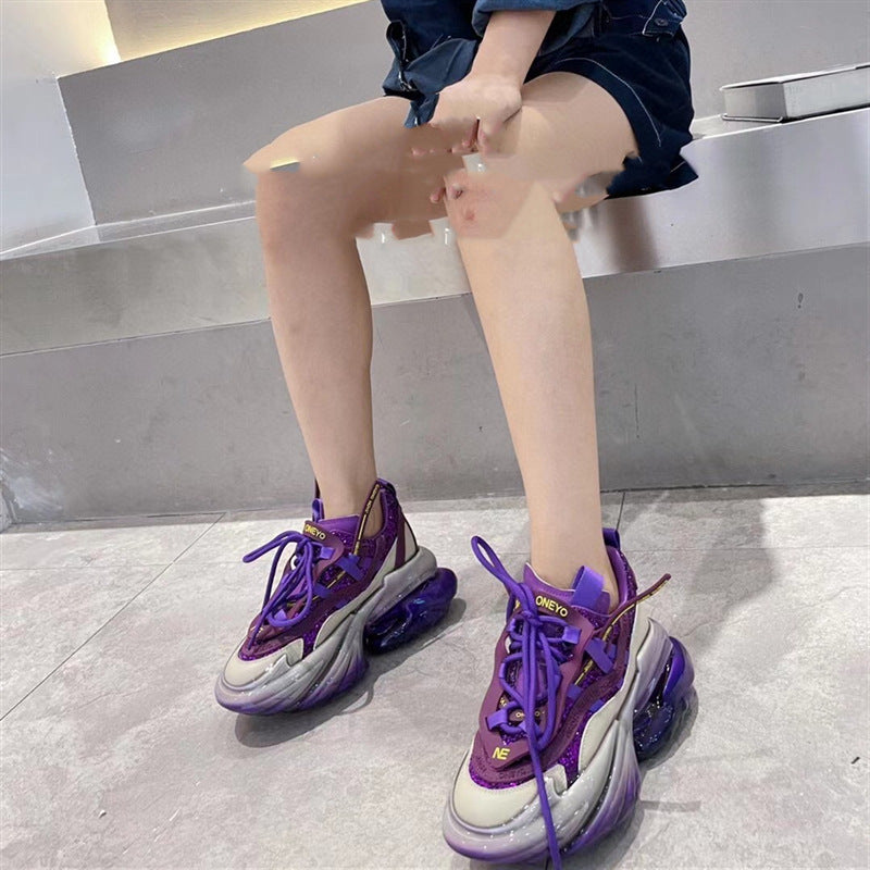 Person wearing purple sneakers on a gray floor.