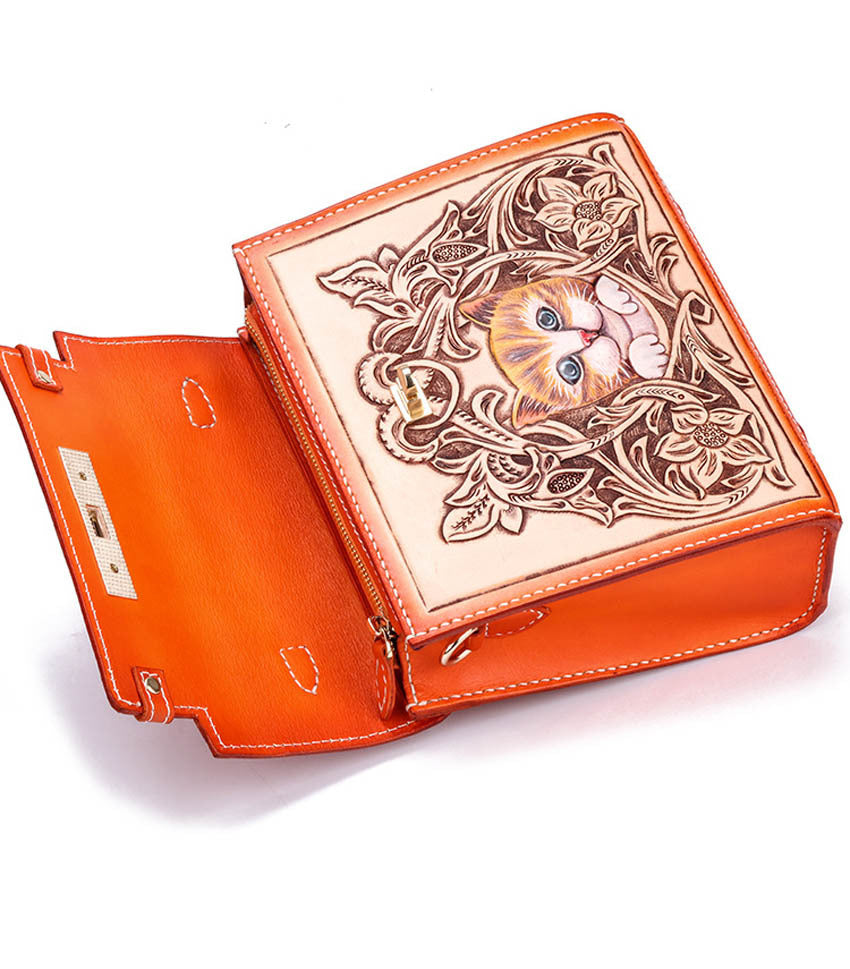 Orange leather-bound book with a cat illustration on a white background