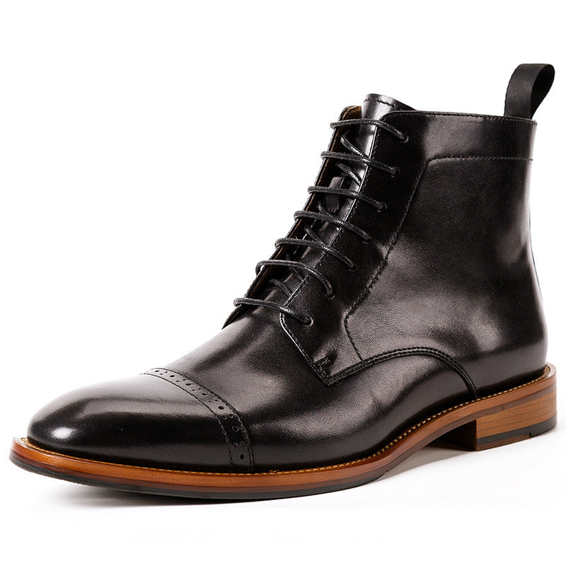 Black leather boot with brown sole on a white background