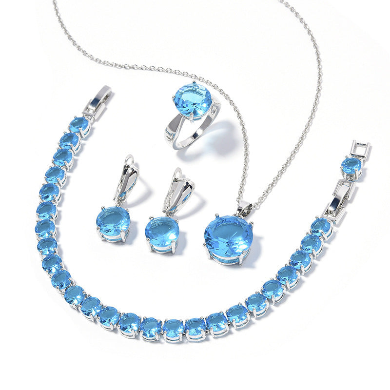 Jewelry set with blue gemstones on a white background