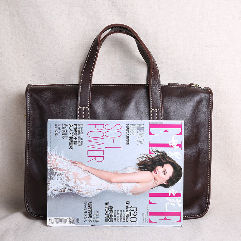 Brown leather handbag with a magazine featuring a woman on the cover.