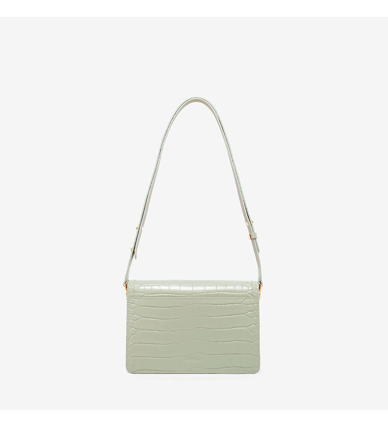 Light green handbag with a strap on a white background