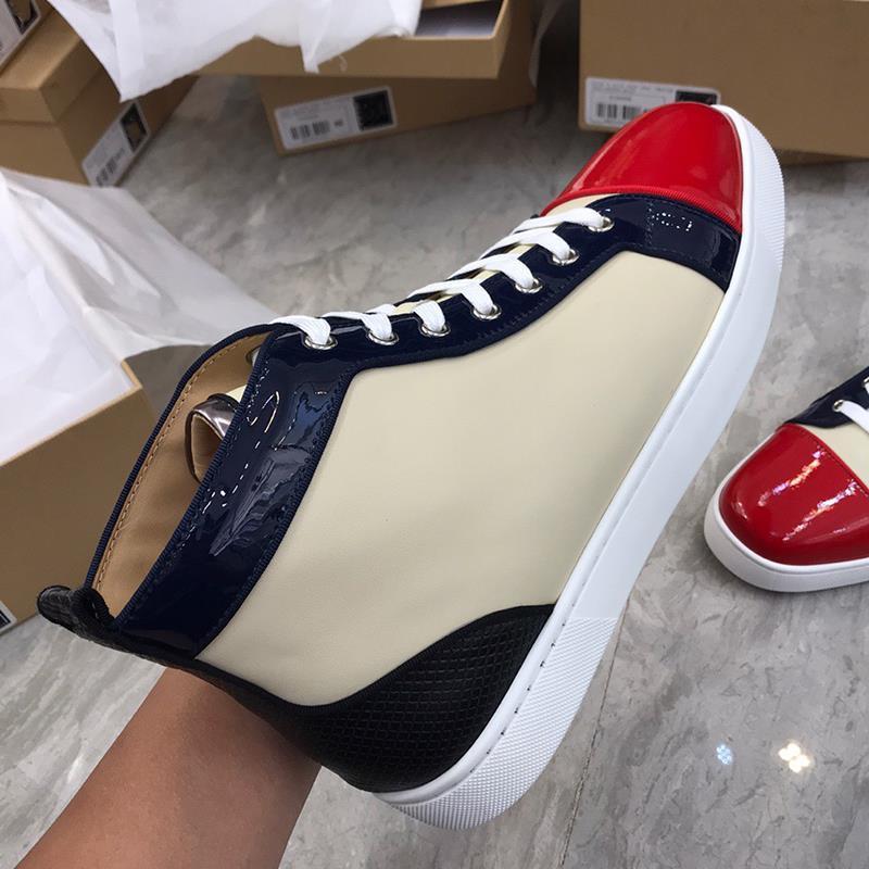 Close-up of a sneaker with red, white, and blue design held by a person.