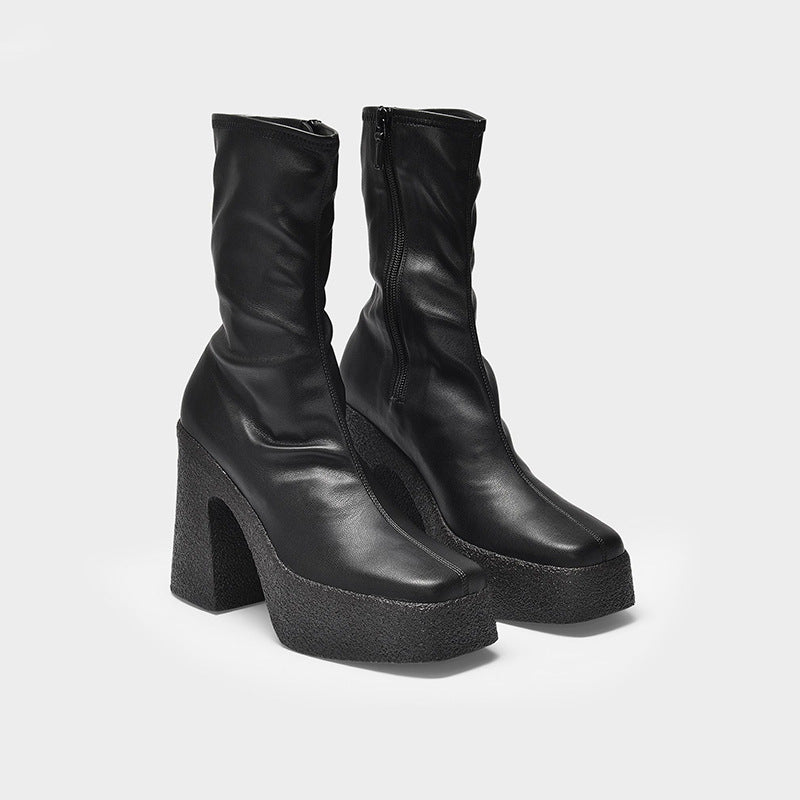 Black platform boots on a white background