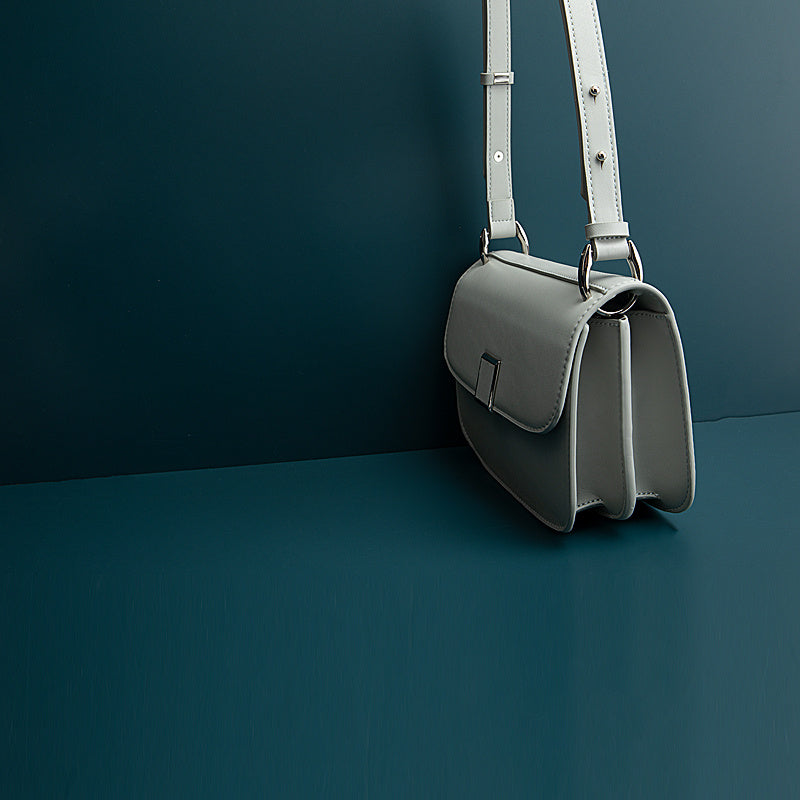 Gray handbag on a dark green background