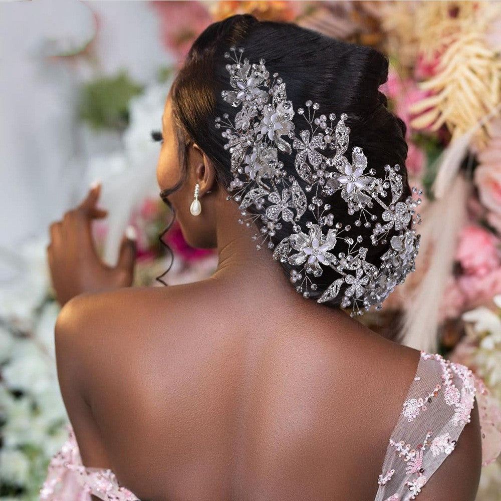 Woman with an elaborate floral hairpiece in a wedding setting