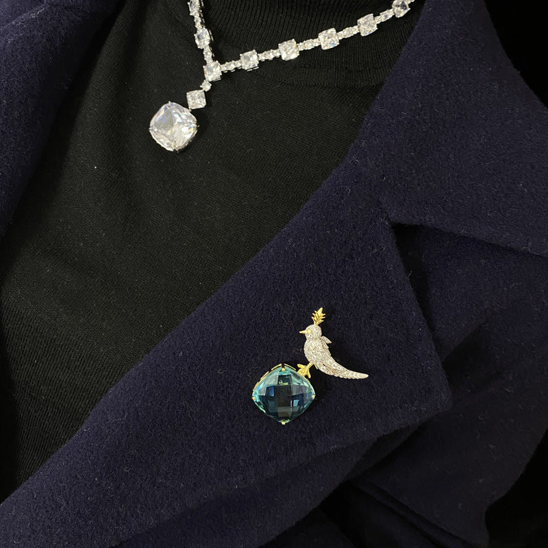 Necklace and brooch on a dark fabric background