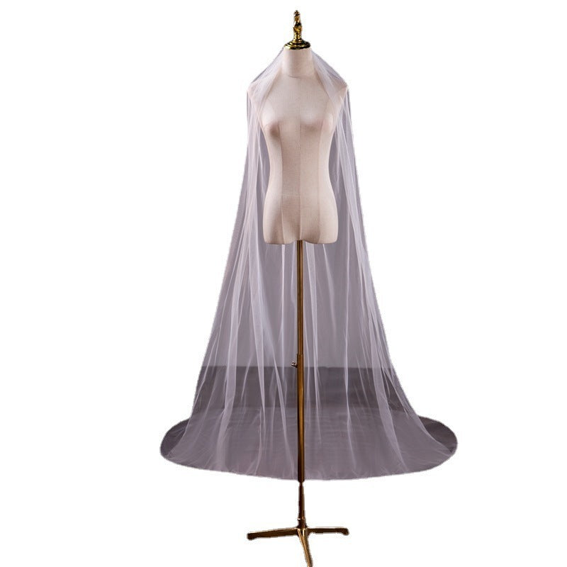 Mannequin wearing a sheer white veil on a white background