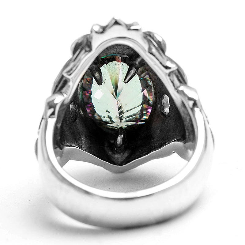 Silver ring with a green gemstone on a white background