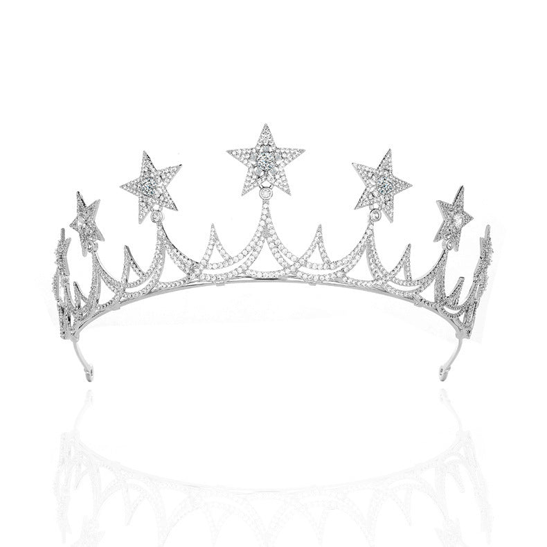 Silver tiara with star-shaped embellishments on a white background