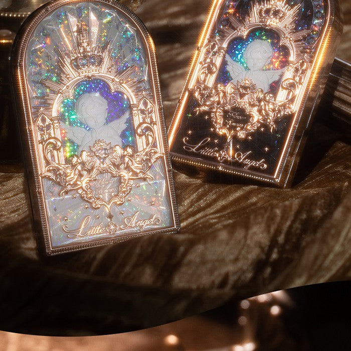Decorative boxes with angel design and 'Little Angel' text on a textured surface