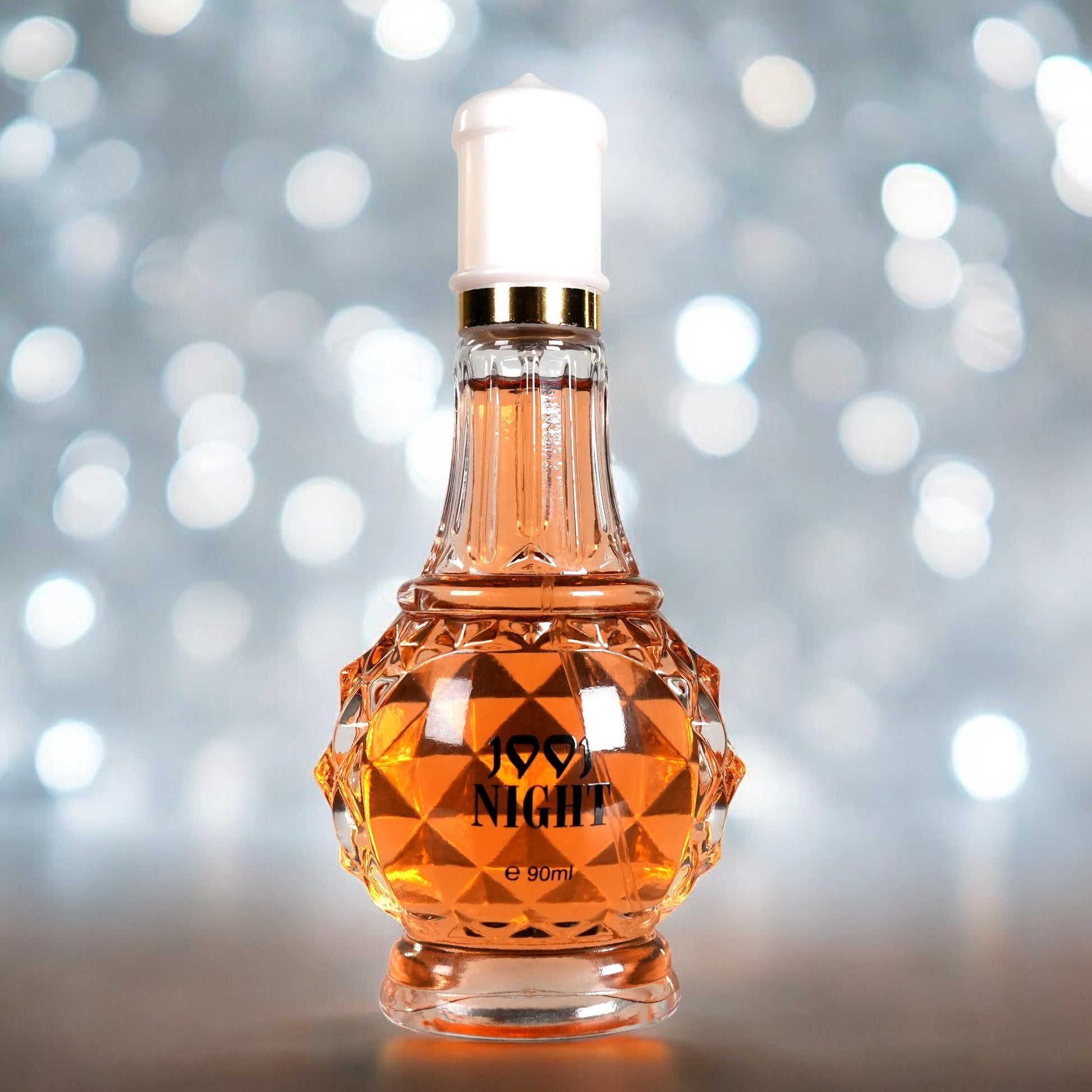 Perfume bottle labeled '99.9 Night' on a blurred background