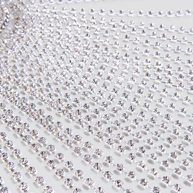 Close-up of a row of clear rhinestones on a white background