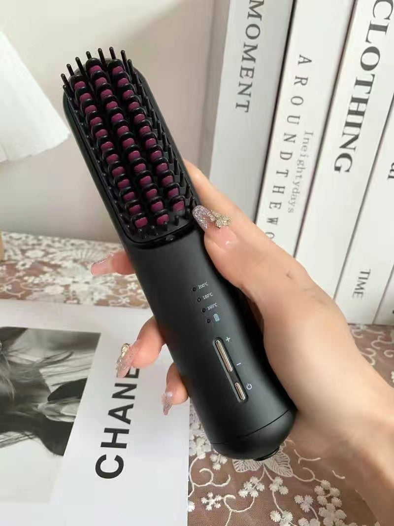 Hand holding a black hairbrush with bristles on a magazine background