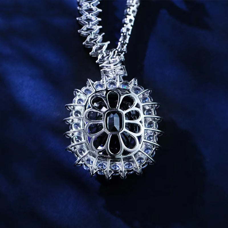 Silver necklace with a detailed pendant on a dark blue background